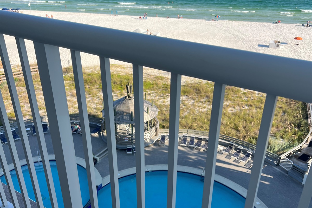 View of pool and beach from balcony