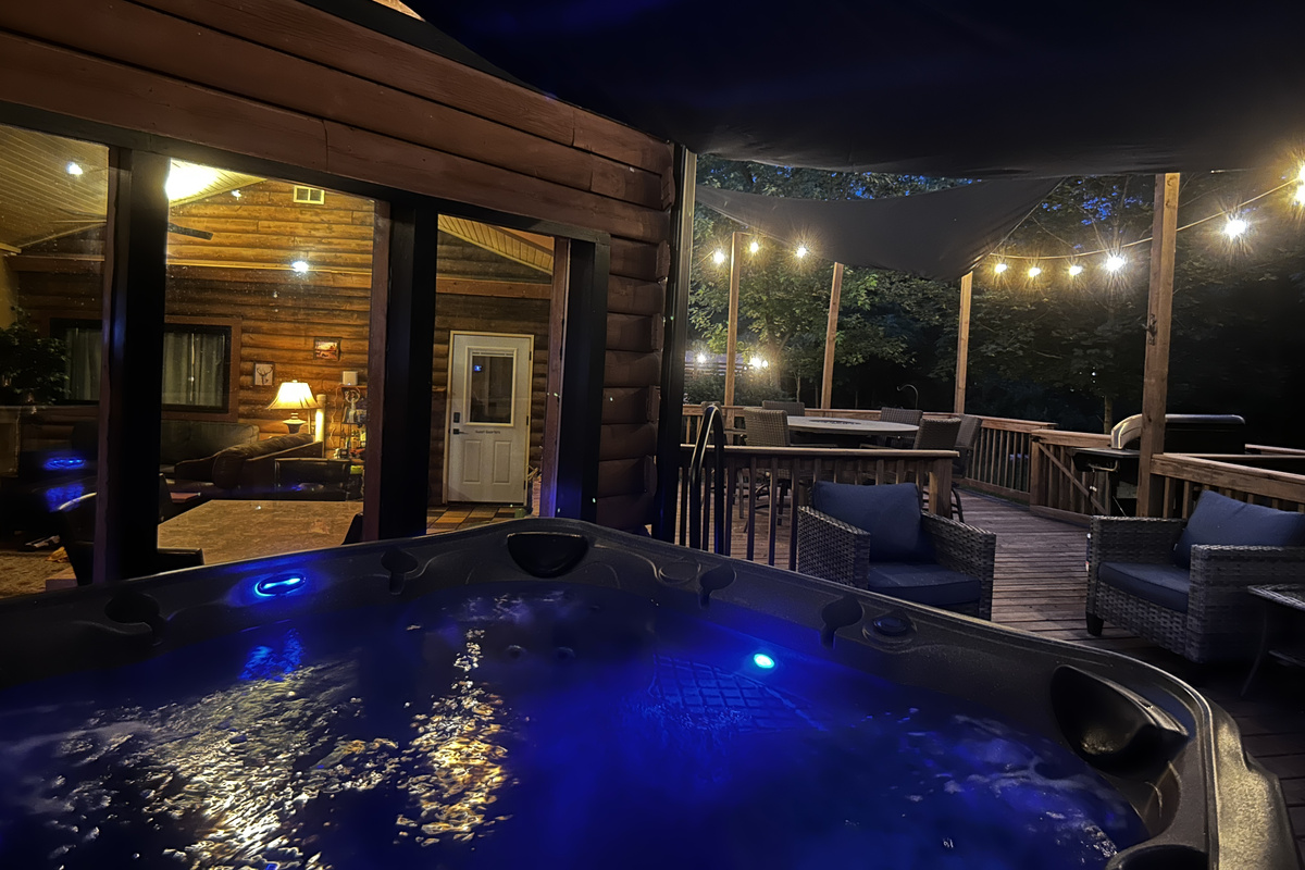 Relax in the 7-person hot tub under the cafe lights at night.