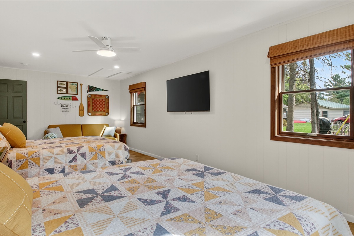 Two queen beds, Roku TV, and couch. This room has only a dresser for clothing storage.