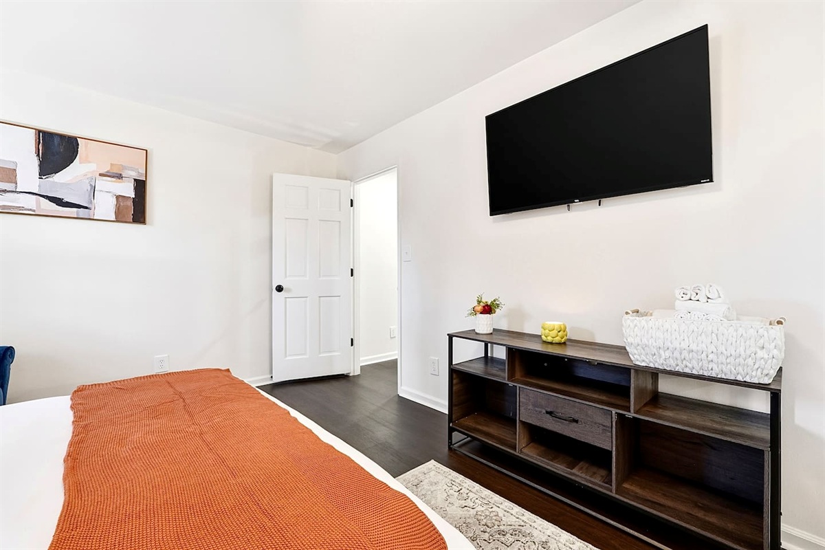 Located furthest to the left at the top of the stairs, this warm and inviting bedroom features two double beds, a smart TV, and a private en-suite master bathroom. This room includes 4 full-body towels, 4 washcloths, and 2 hand towels for your stay.