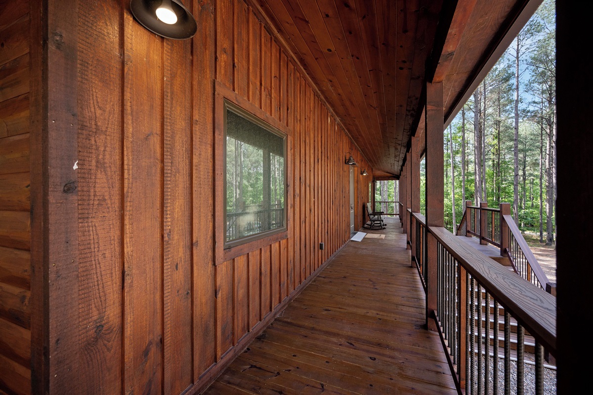 The wide porch encircles the entire cabin, with several areas for relaxing