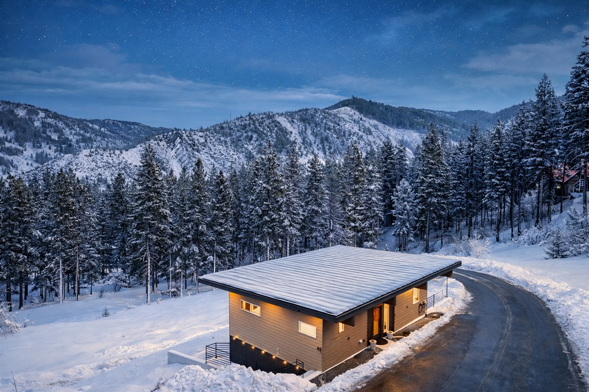 Winter vibes: Front entrance and parking area for two vehicles, plus EV charger