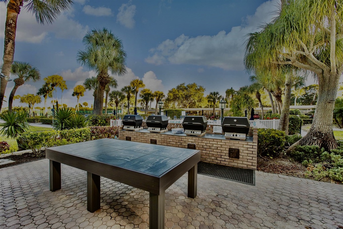 Outdoor grill under the palm trees.