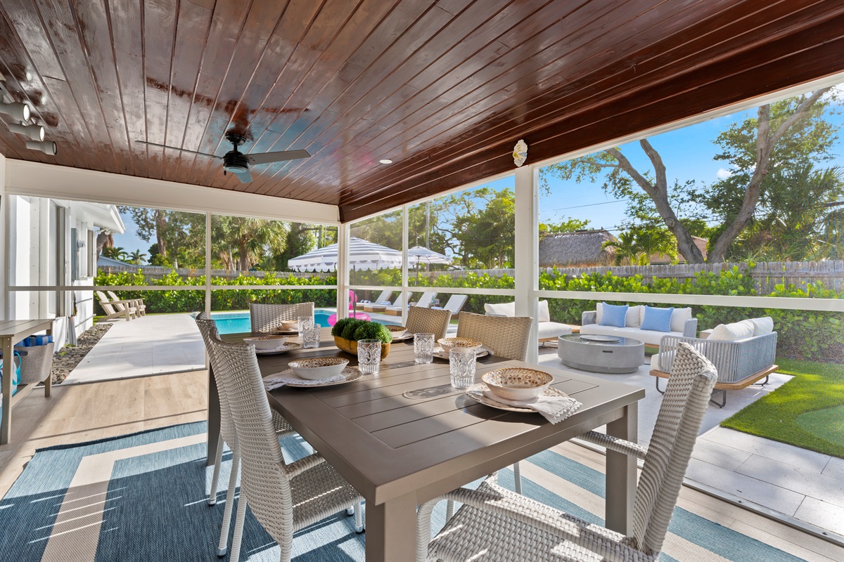 This screened-in outdoor retreat blends indoor luxury with tropical living — ideal for alfresco dining, morning coffee, or peaceful evenings outside.