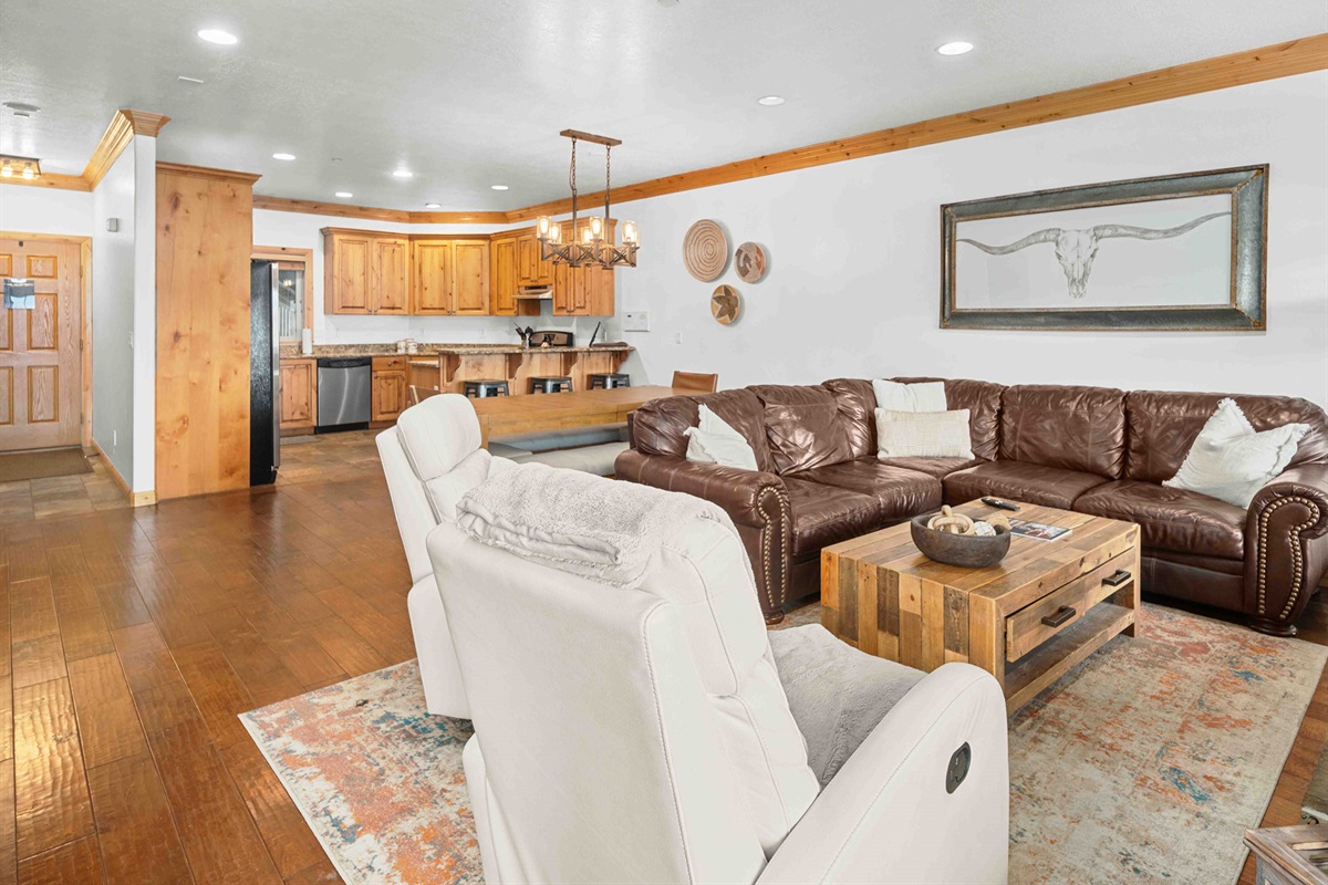 Spacious open-concept living area with comfortable seating and mountain-inspired décor.