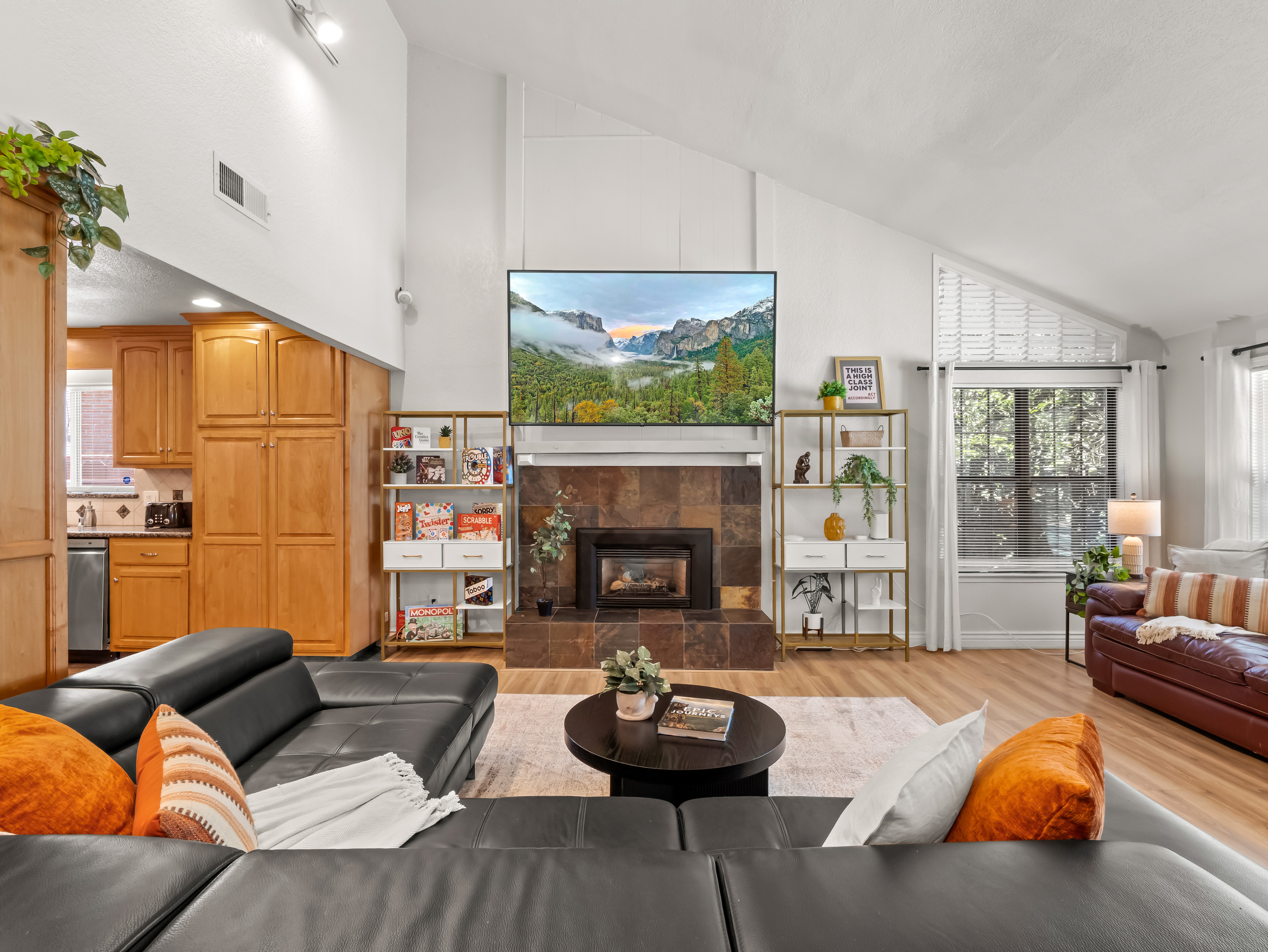 Gather everyone together in this bright and welcoming living room, where comfortable seating, a cozy fireplace, and a large TV create the perfect setting for relaxing after a full day.