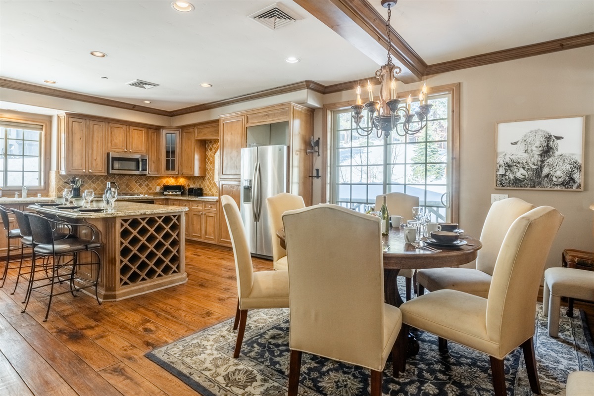 The Nest's dining area opens directly into the kitchen, with a generous table and breakfast bar offering flexible seating for meals, games, or planning the day.