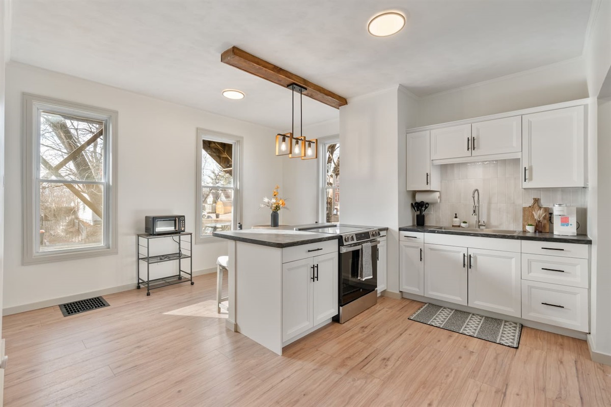 Full kitchen with a microwave, electric stove/oven and extra large sink. 