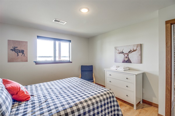 Lower-level bedroom with queen bed and lake-facing window