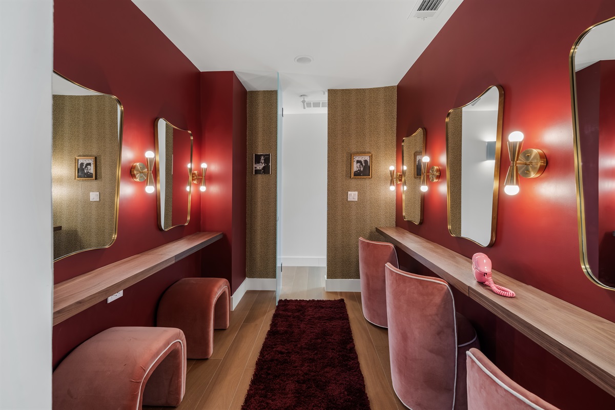 Stylish vanity room with well-lit mirrors and ample counter space—ideal for getting ready comfortably, whether for a night out or a special event.