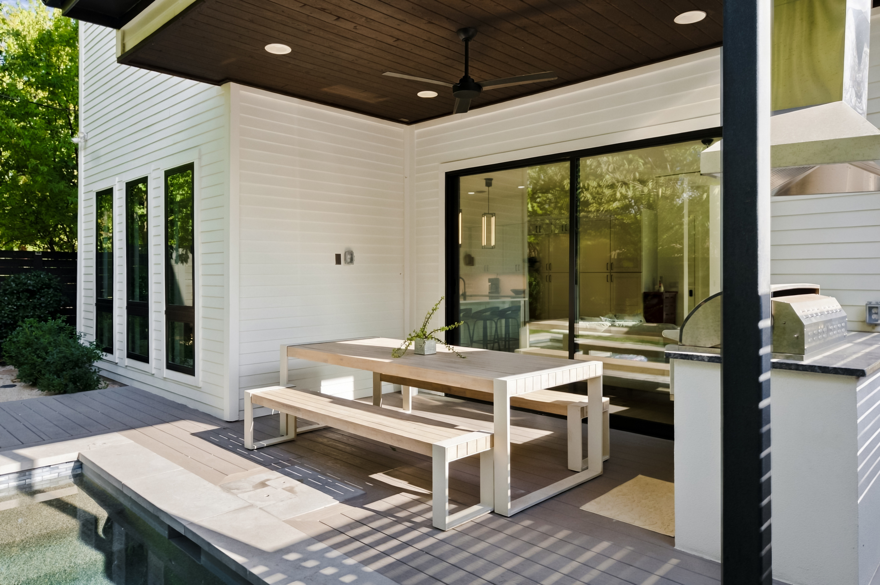 Covered patio dining area opens straight into the home's main living space.