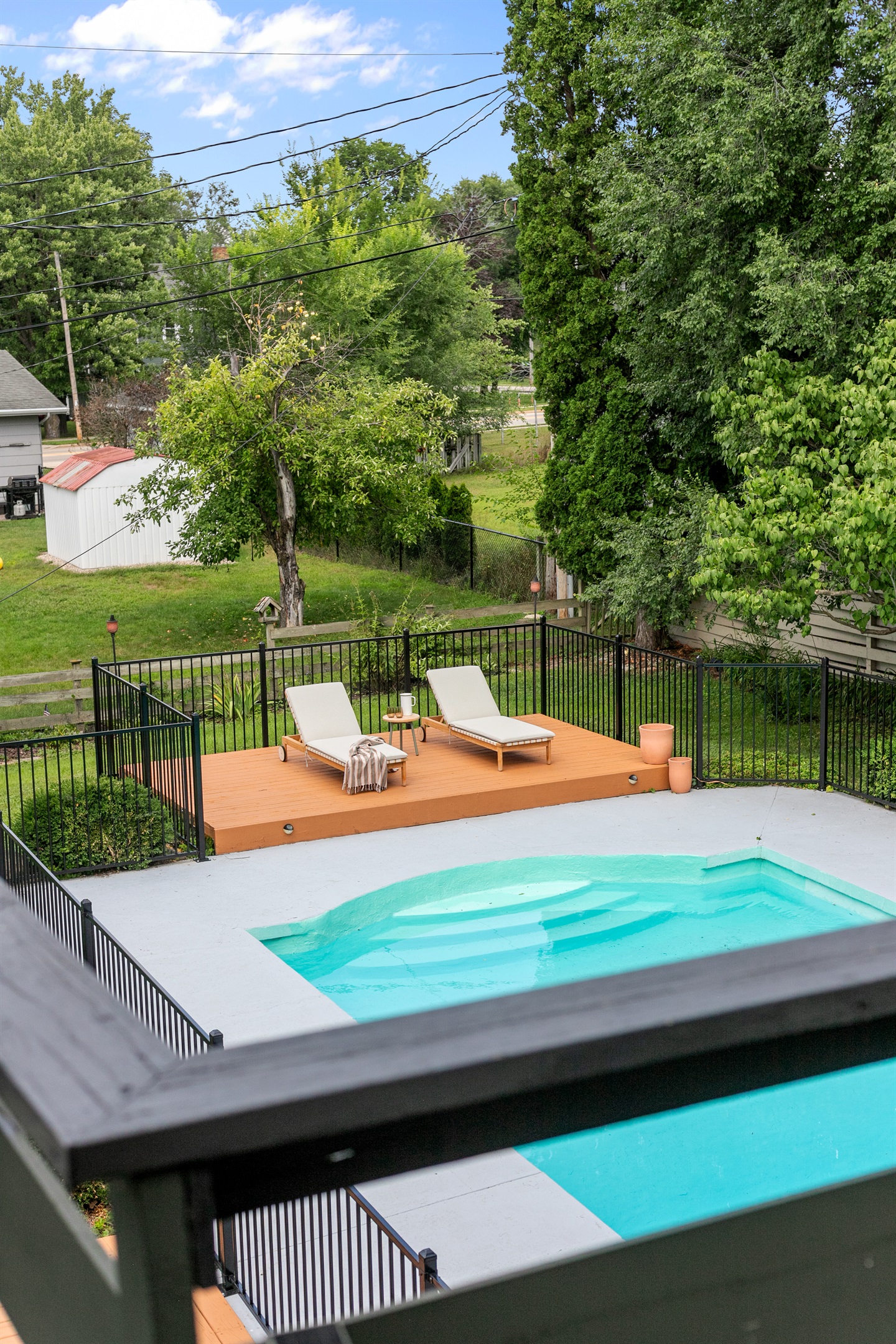 The pool area includes a spacious lounging deck, the perfect spot to stretch out, soak in the sun, and enjoy carefree afternoons by the water.