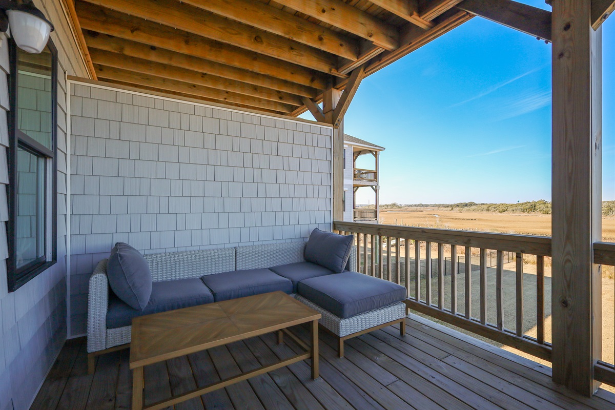 Comfortable outdoor seating tucked under cover&mdash;ideal for winding down after beach days