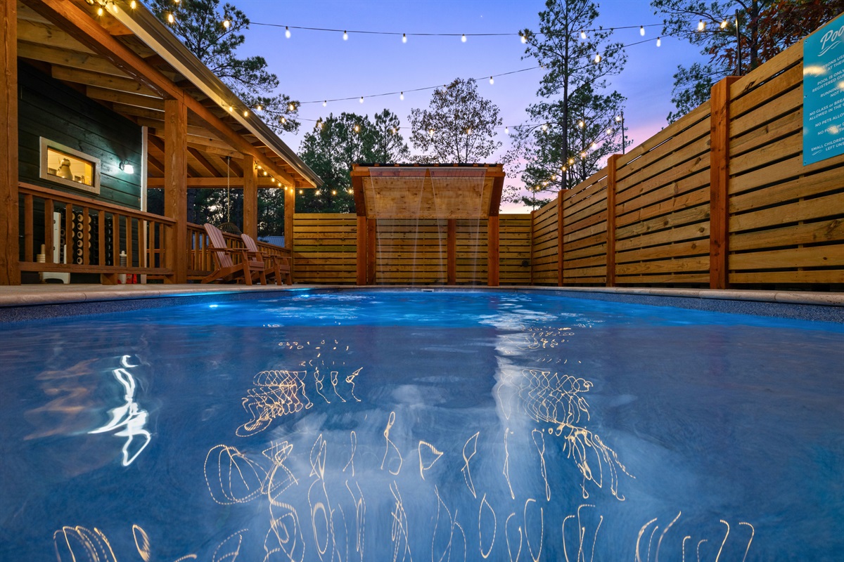 The glow from the twinkle lights and the shimmer of the pool make this whole area feel like your own private retreat.