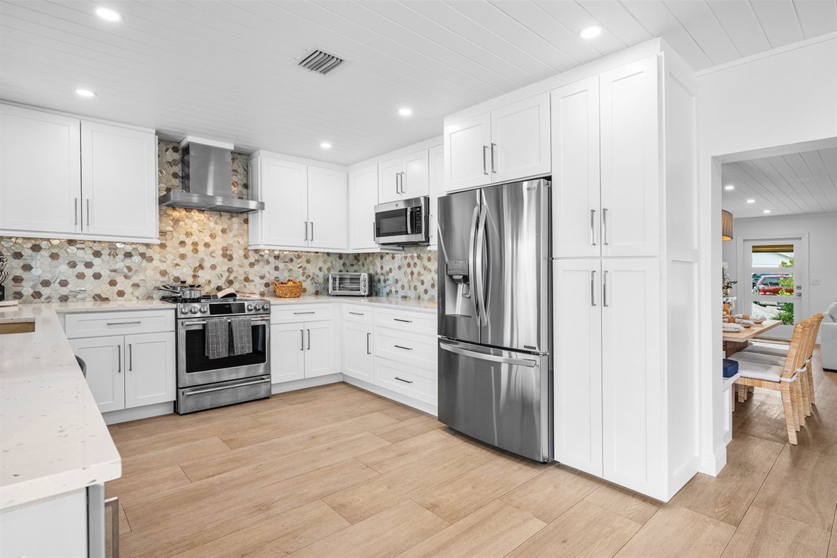 Spacious kitchen with stainless steel appliances and abundant storage