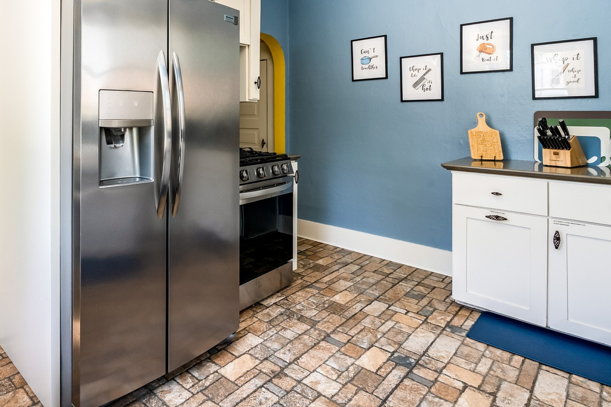 A true cook's kitchen featuring a premium gas range and ample stainless steel refrigeration. You'll find plenty of dishes, silverware, coffee cups, glasses, wine glasses and more for your group.