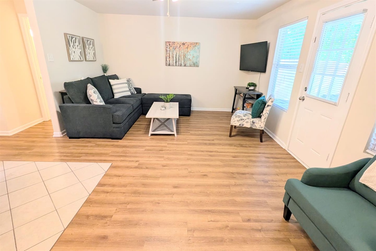 The open-concept living area flows easily to the large, covered deck area and fenced back yard for guest use. 