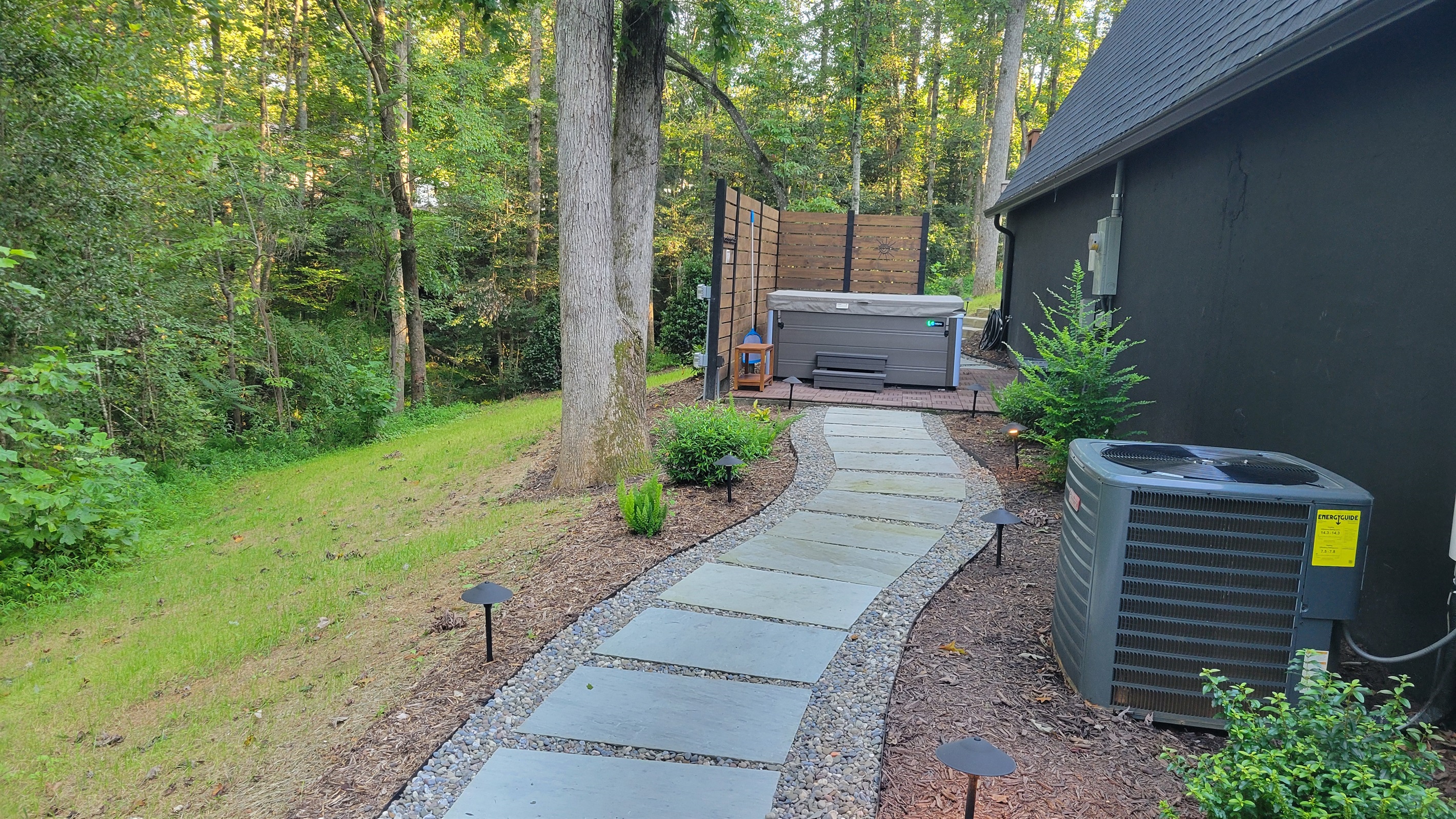 Paver walkway to the private hot tub patio area