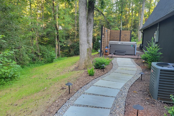 Paver walkway to the private hot tub patio area