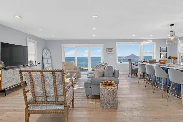 Spacious open living area designed for relaxing, dining, and entertaining by the water