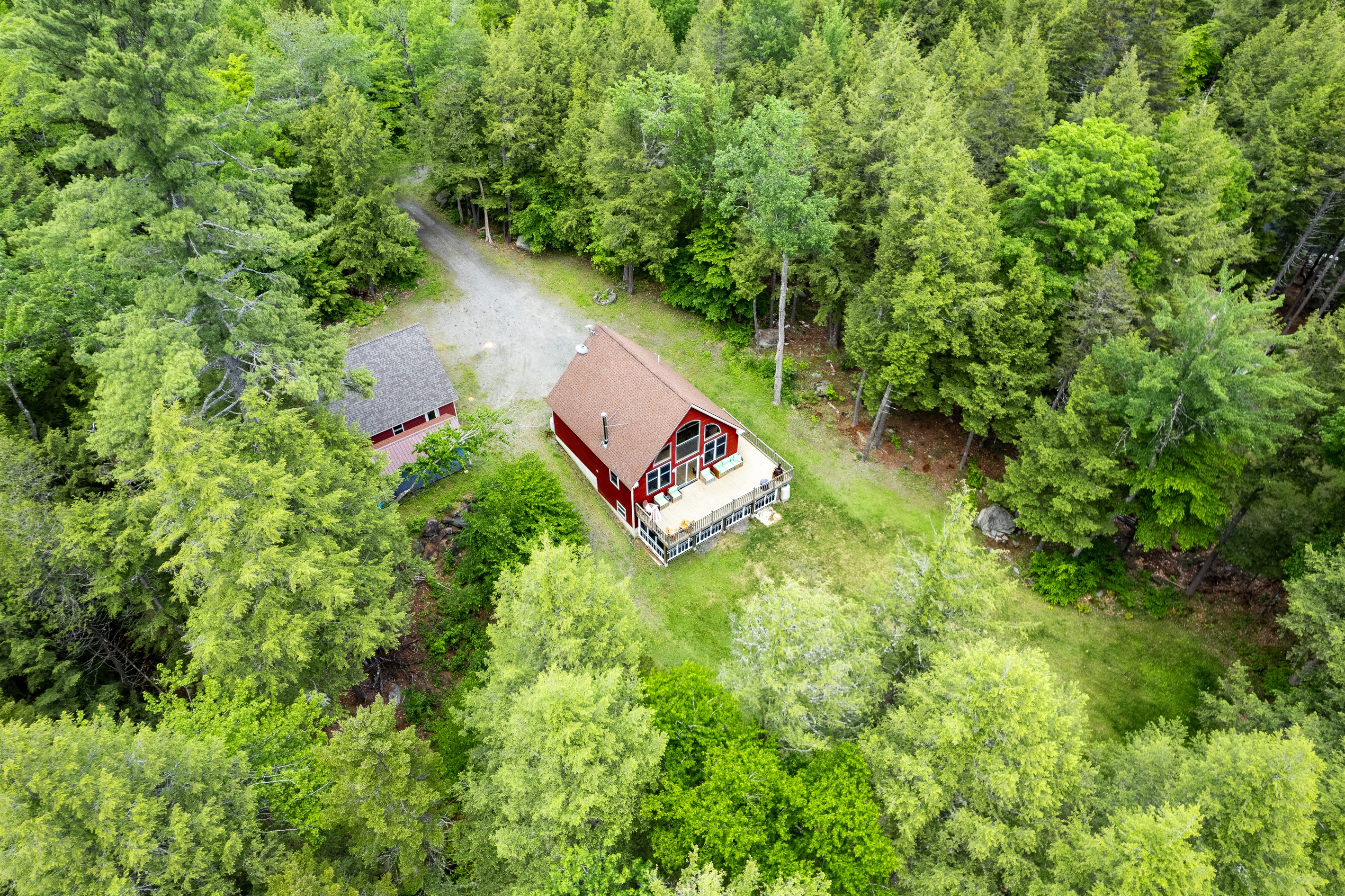 Private lake access with a dock in protected cove, large parking area, large backyard, quiet surroundings.
