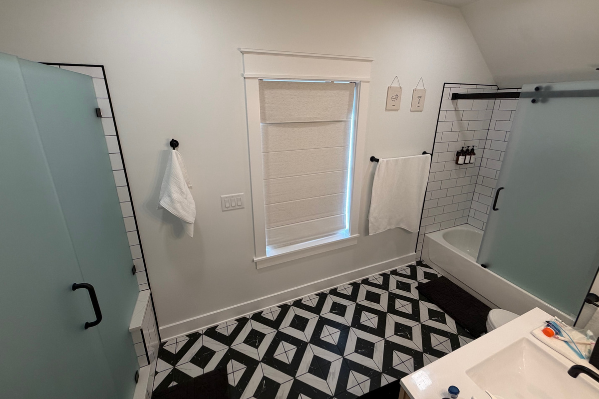 Upstairs bathroom with two showers