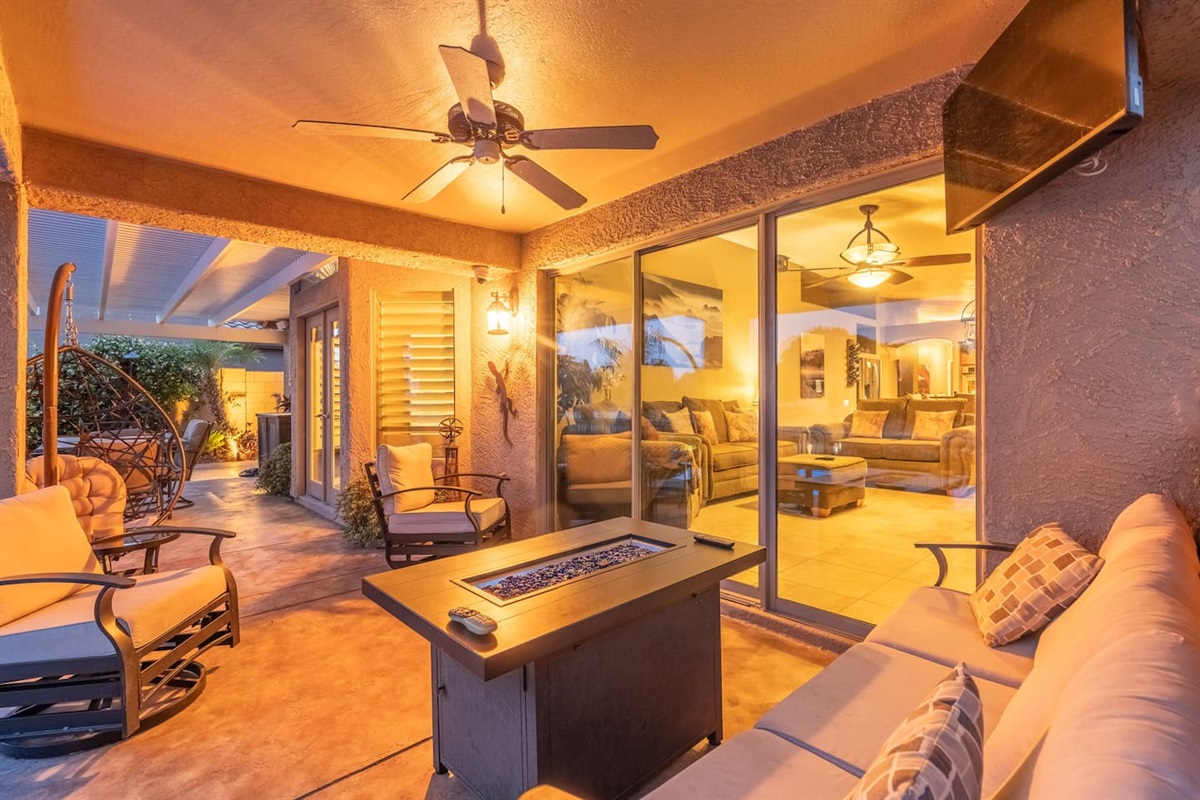 When the temperature drops, gather around the patio fire table under the covered lounge — with the living room just through the sliding doors, the indoor-outdoor flow makes hosting effortless.