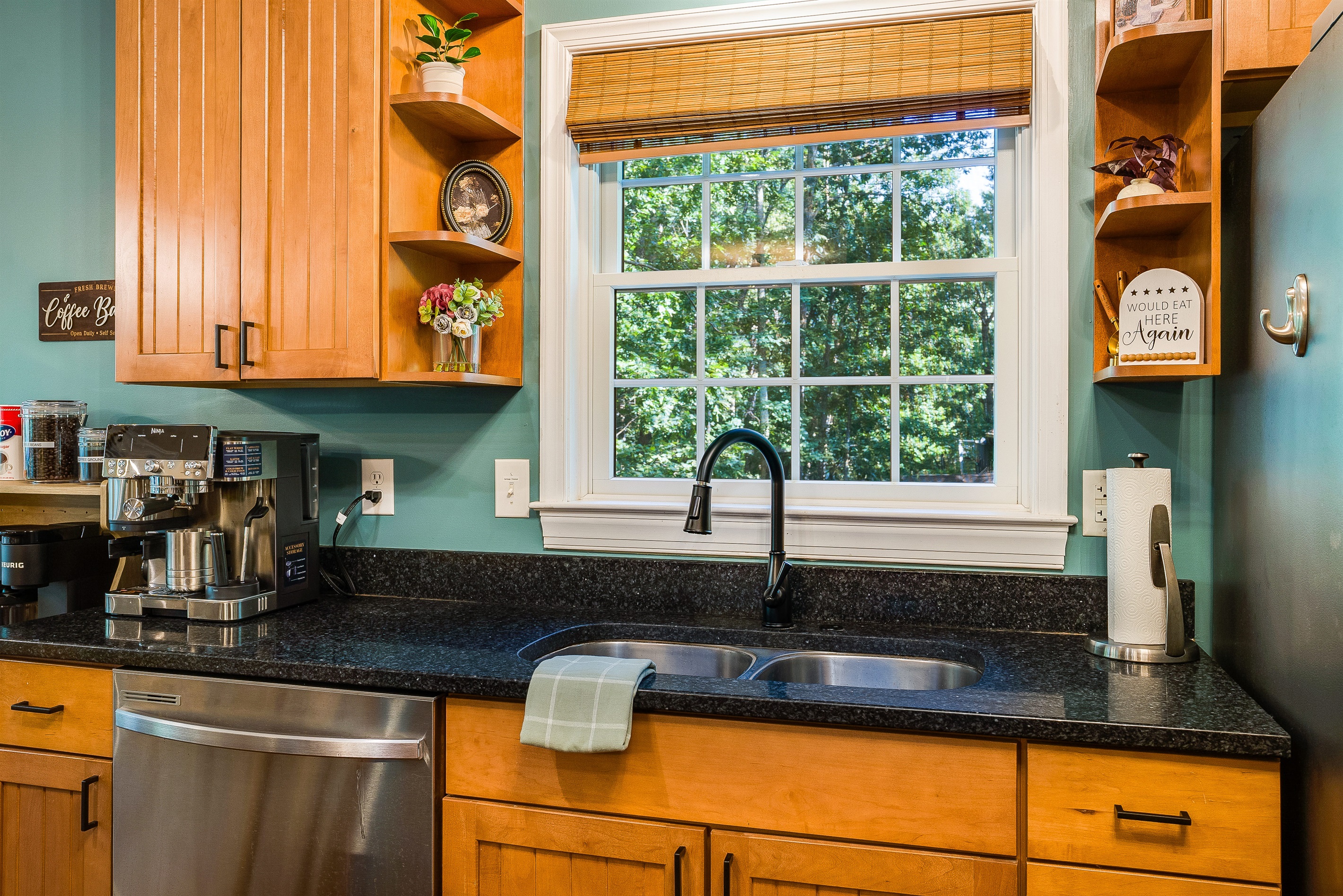 Even doing the dishes feels better here — enjoy the wooded view right outside the kitchen window.