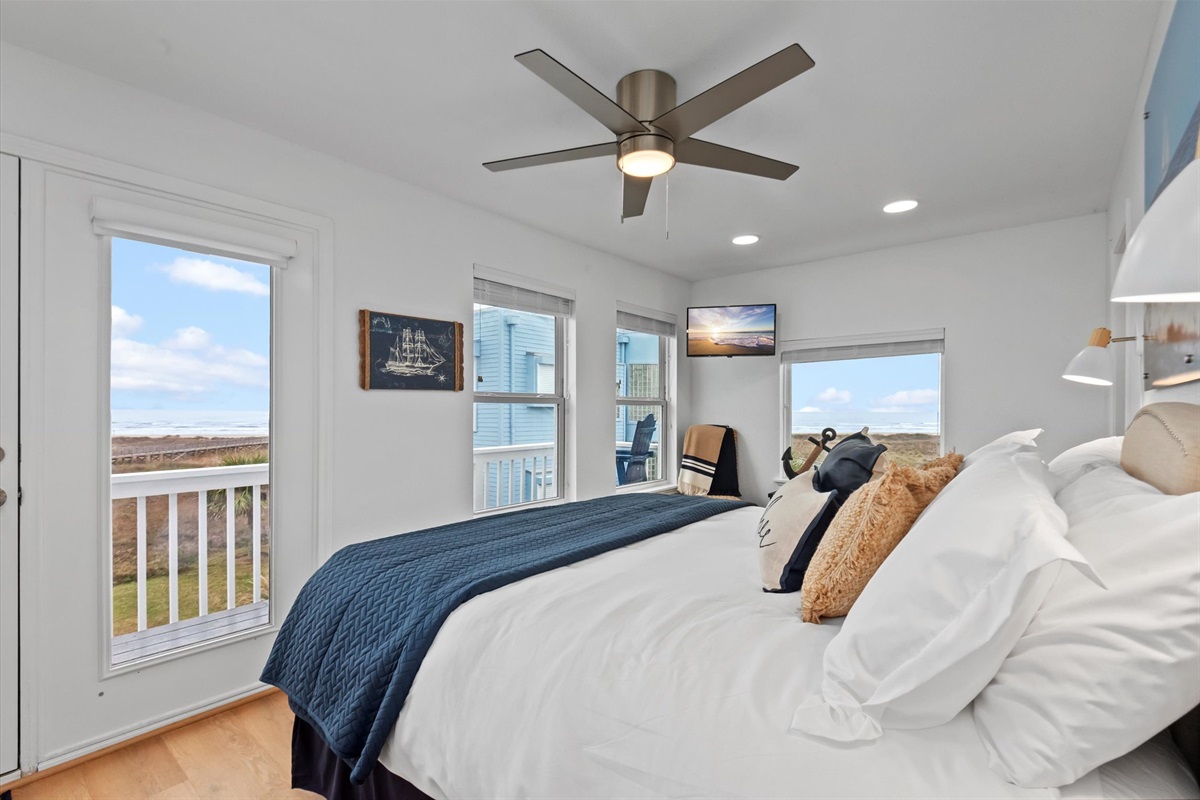 The Captain's Cove master bedroom located on the second floor boasts a spacious and regal atmosphere with a King Bed, private balcony.