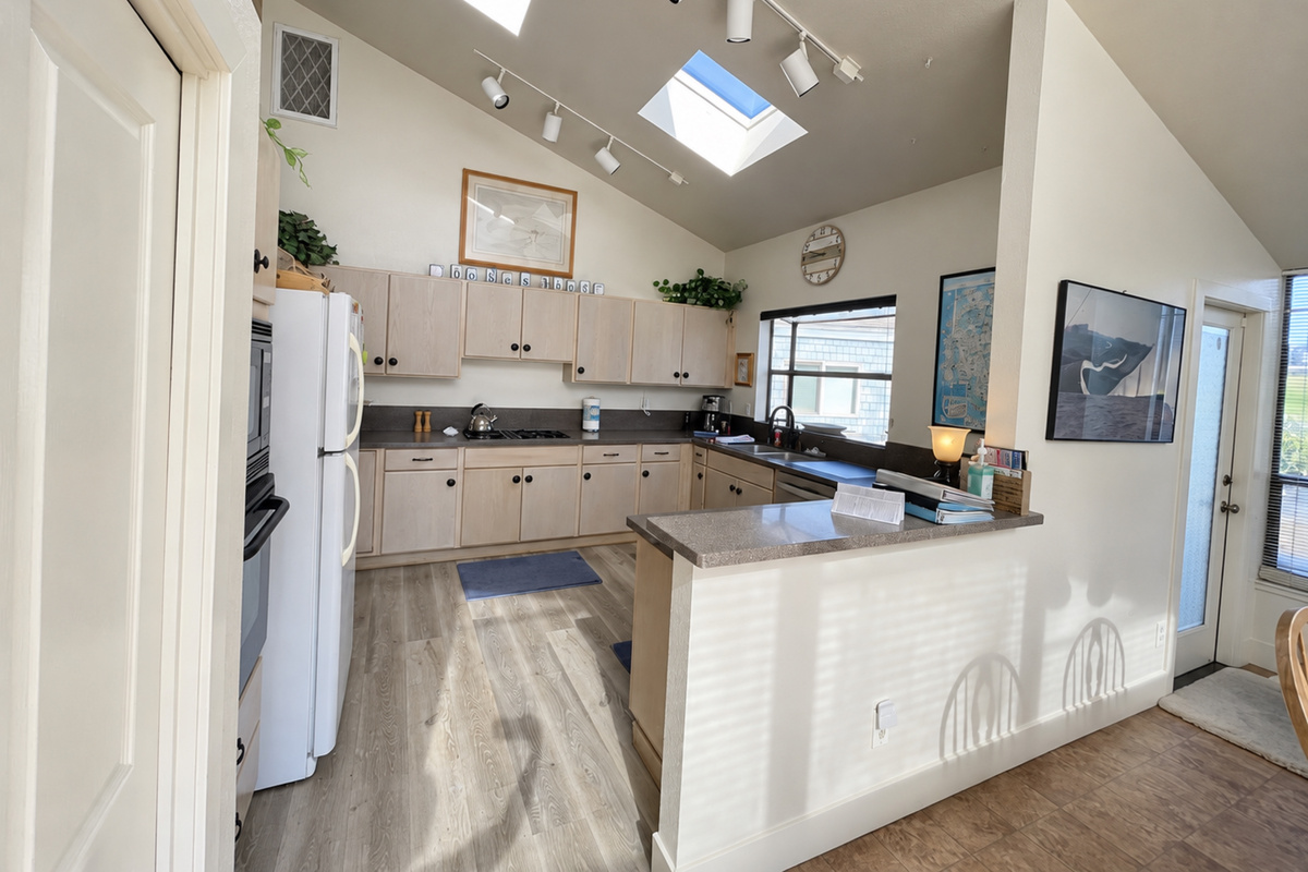 kitchen's open floor plan with natural lighting from double skylights