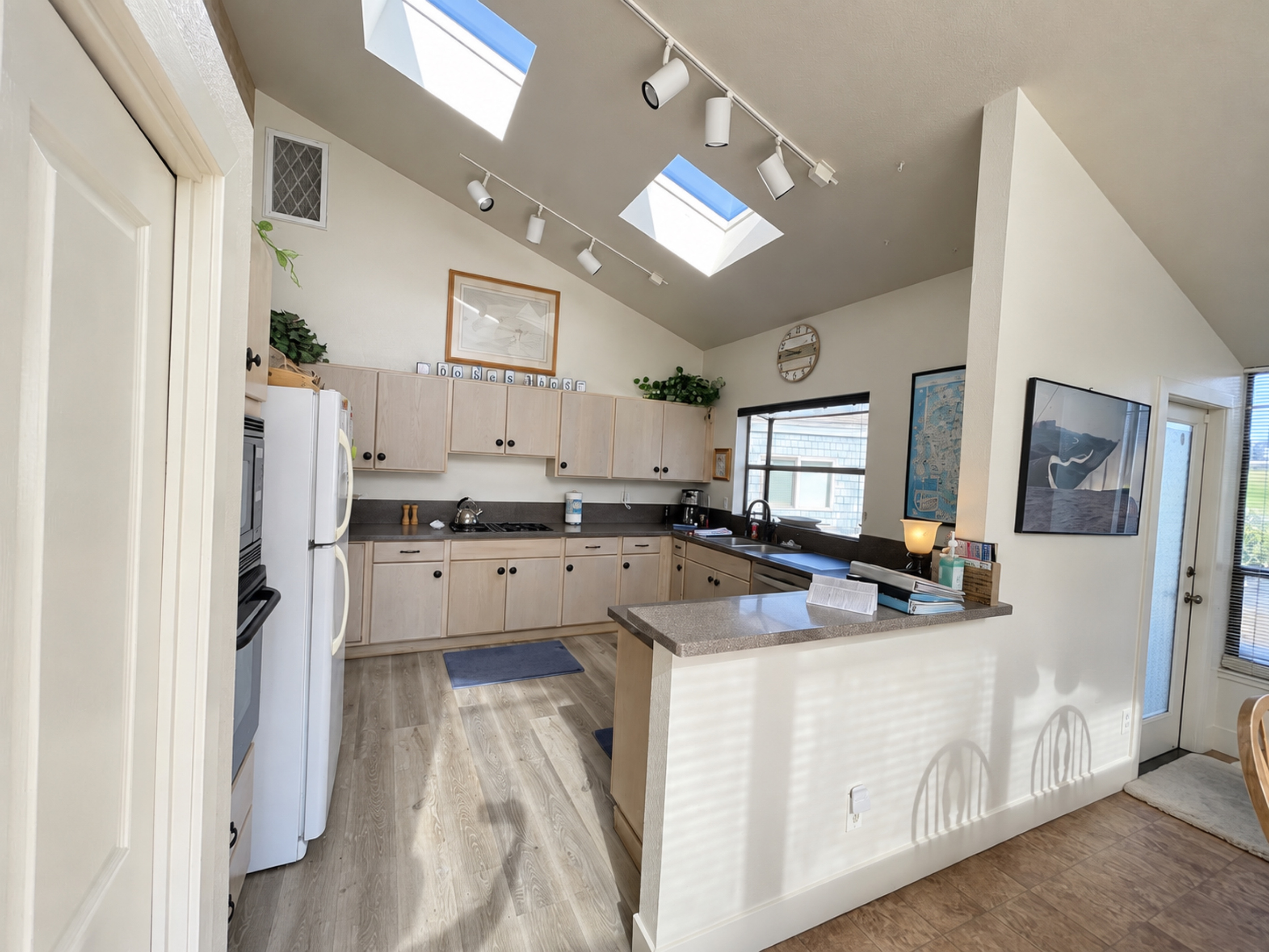 kitchen's open floor plan with natural lighting from double skylights