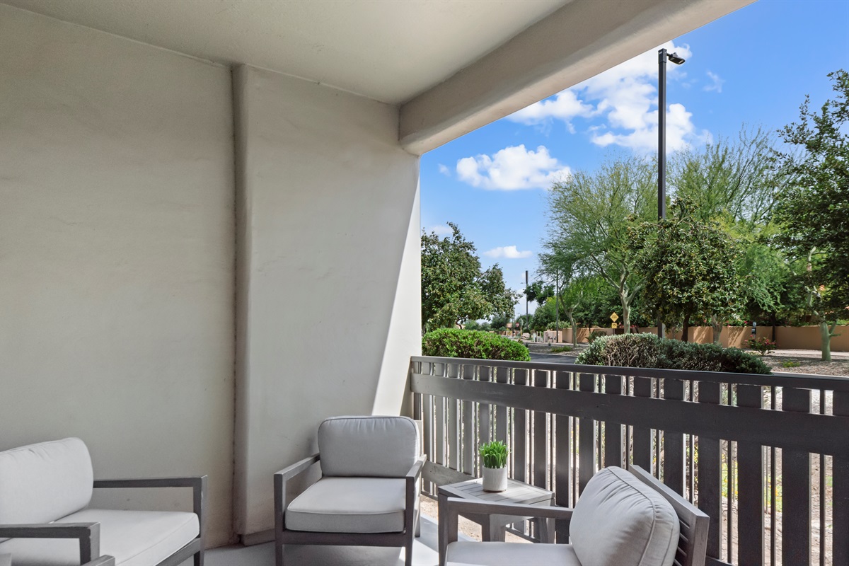 Relax on the private balcony with comfortable seating and peaceful views