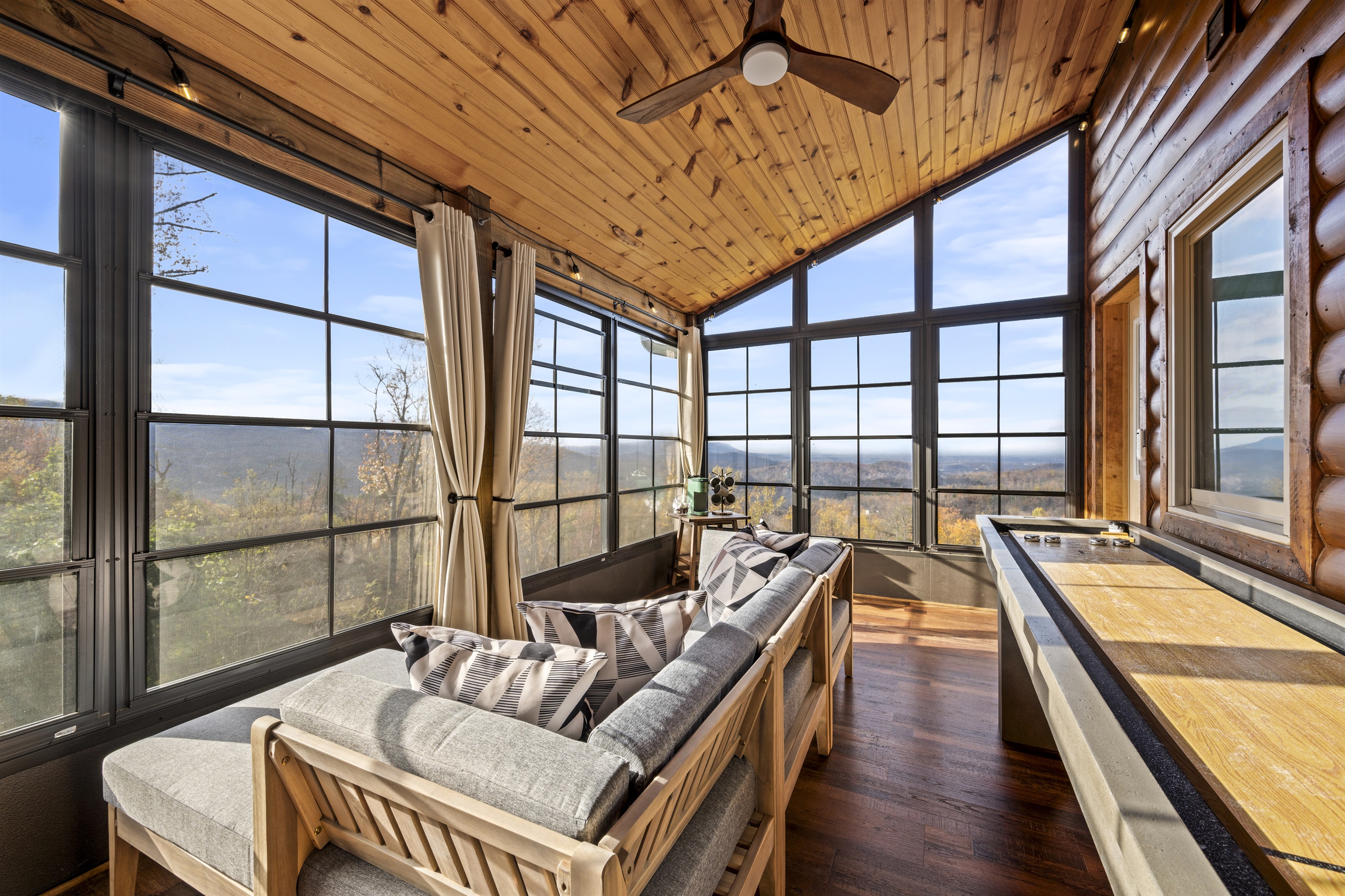 Main floor: Challenge friends and family to a game of shuffleboard in the enclosed deck at Signature Stay, all while enjoying the privacy and stunning mountain views