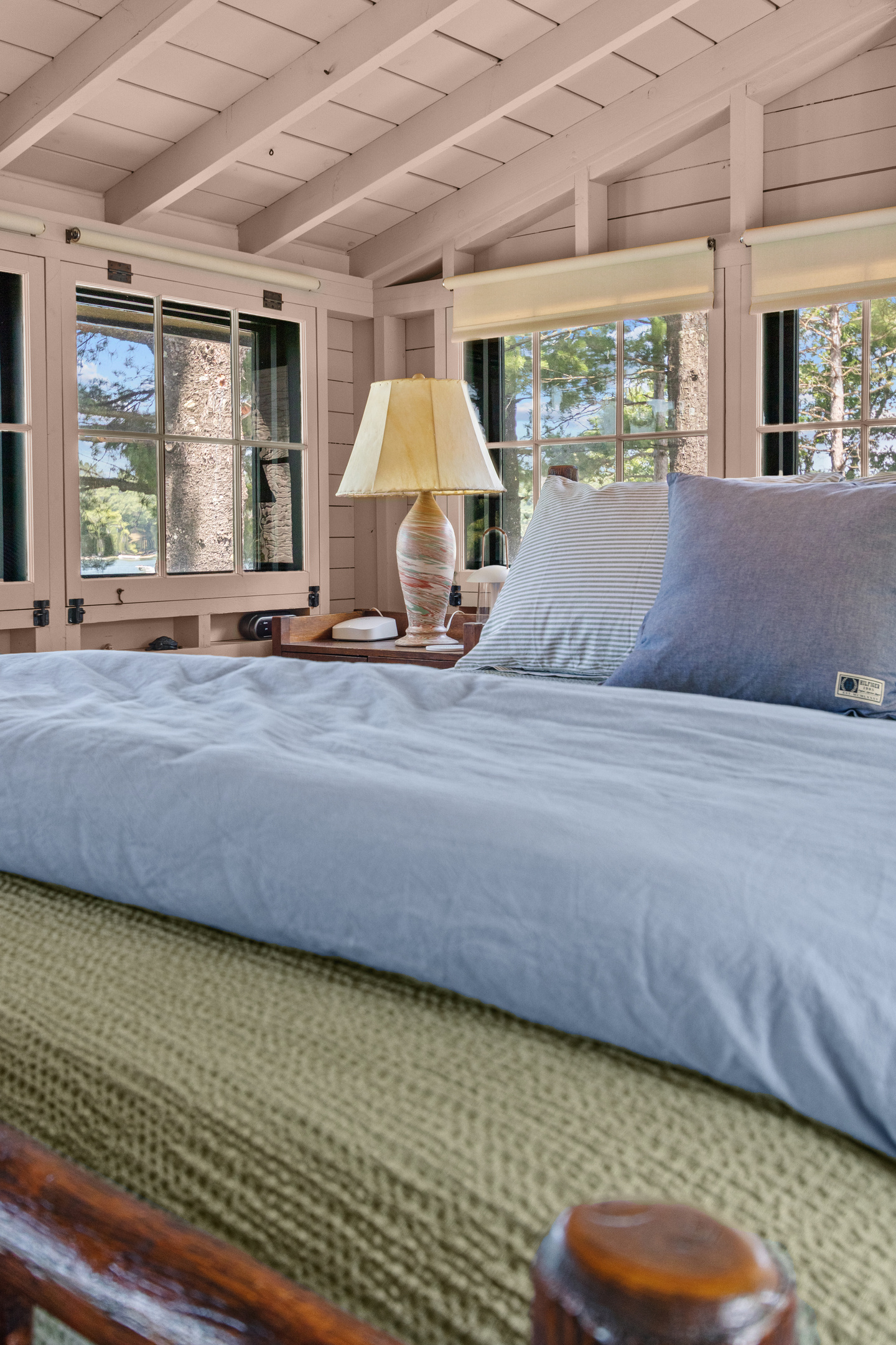 Settle into the king-size bed, turn on the bedside lamp, and unwind surrounded by charming windows and the cozy cottage feel of your lake getaway.