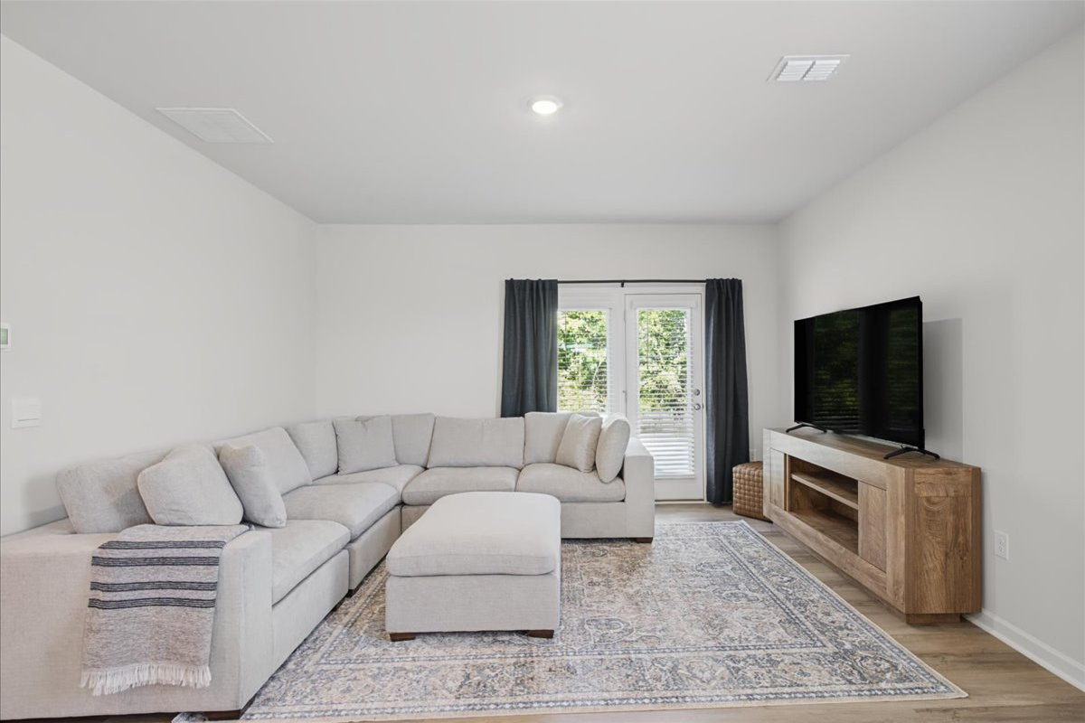 Comfortable living room with a large Smart TV and a sectional sofa, perfect for the whole group