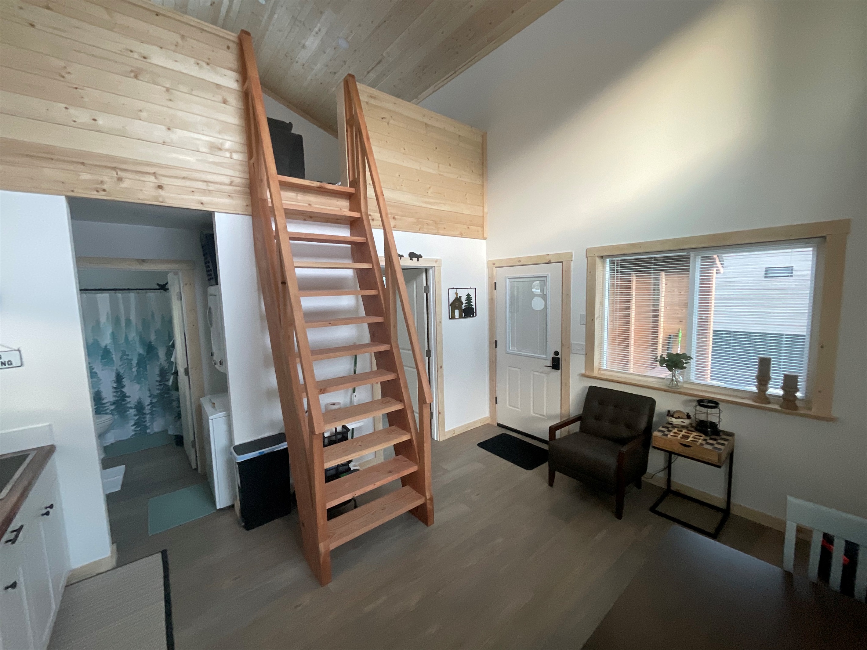 Main floor area.  Bathroom and laundry are in the left front and bedroom is in the left rear.  Ships ladder access to the loft living area and additional sleeping space.