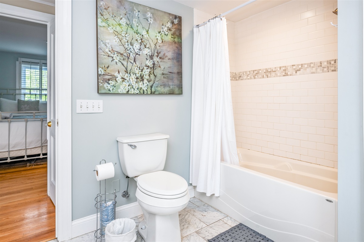 Modern full bathroom with a deep soaking tub, stylish tilework, and calming decor 🚿🛁🖼️
