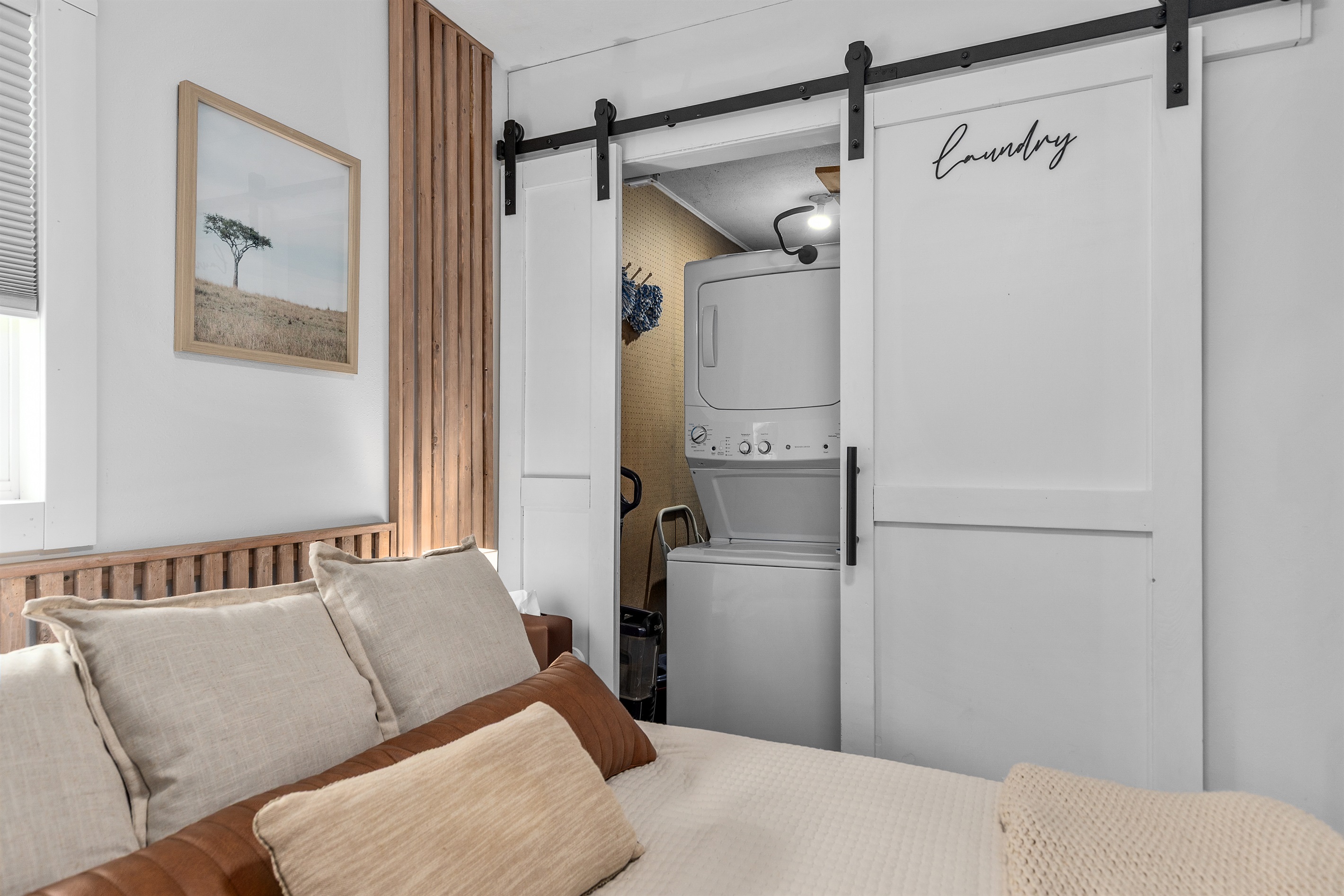 The hidden laundry space behind the barn door adds both style and convenience to your stay
