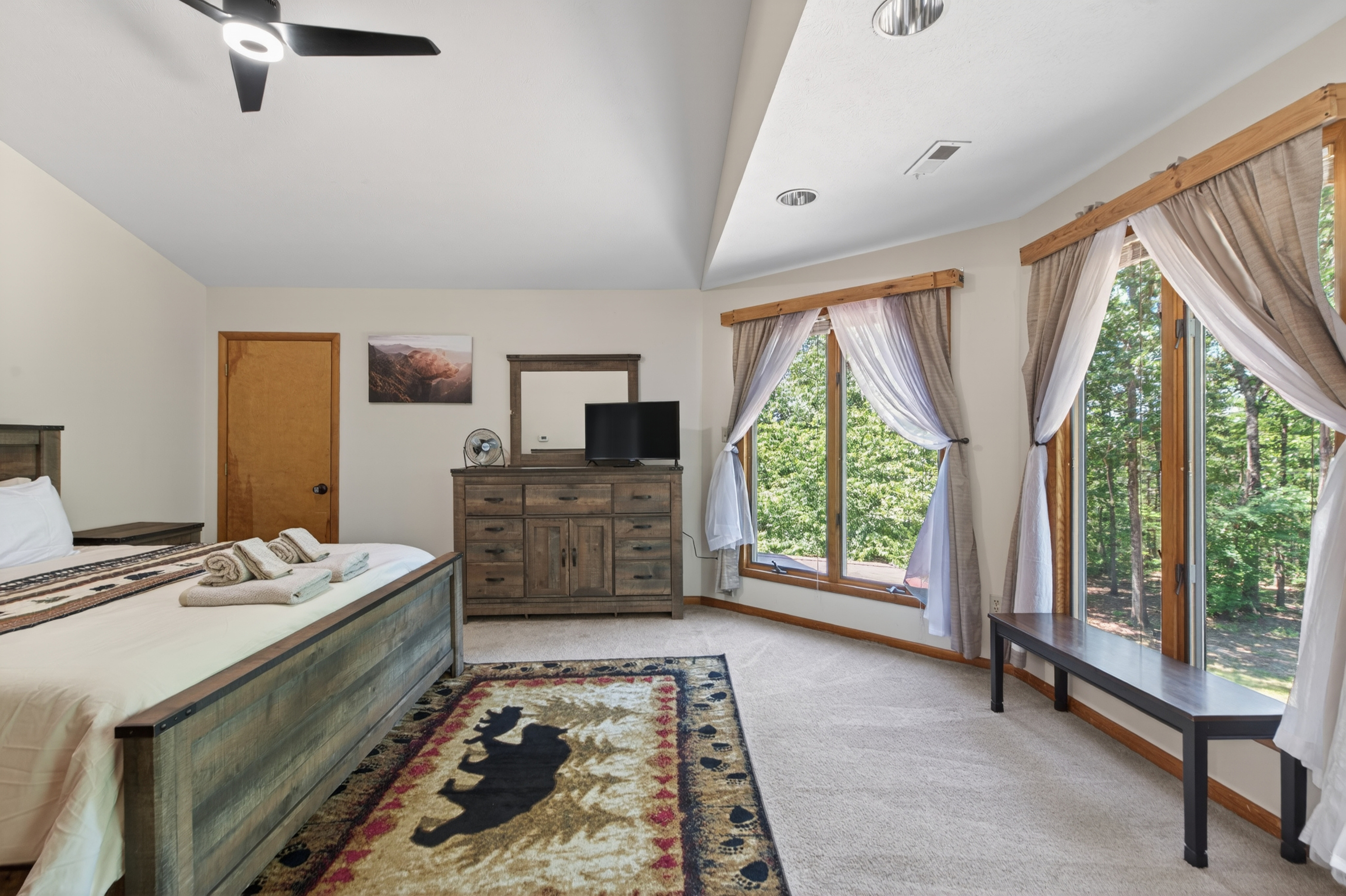 Spacious Bedroom 1: Wake up to serene views and stylish decor in a tranquil woodland escape!