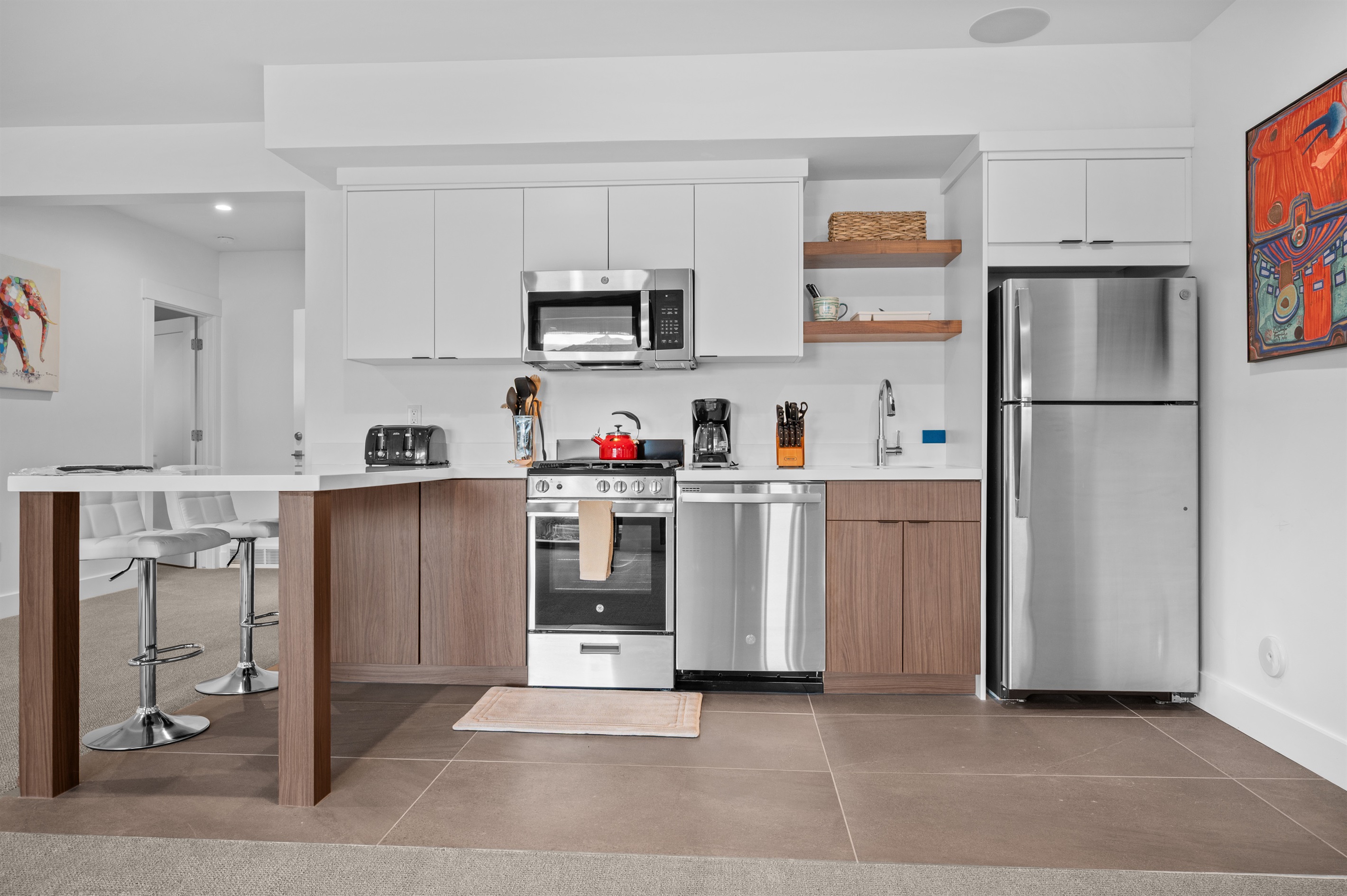 Fully equipped second kitchen with modern appliances and seating, ideal for multi-family stays.