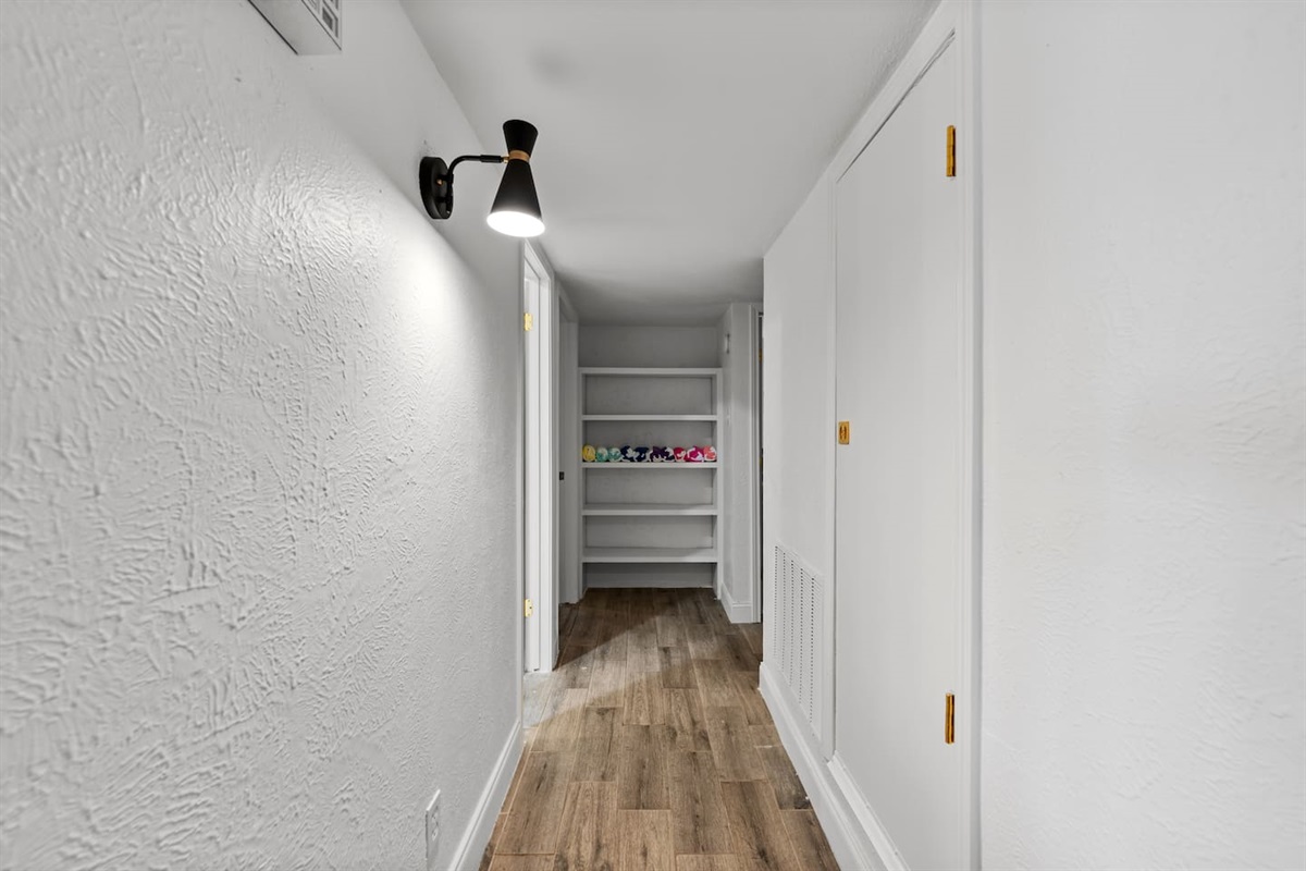 Clean, wide hallway with modern finishes that connect the home’s stylish layout.