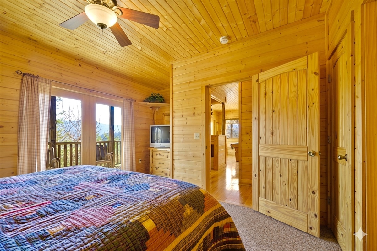 Bedroom #3 - Step from your cozy bed onto your own private deck and greet the morning mountain air. With natural light and wood accents, this serene suite is made for slow mornings and quiet moments.