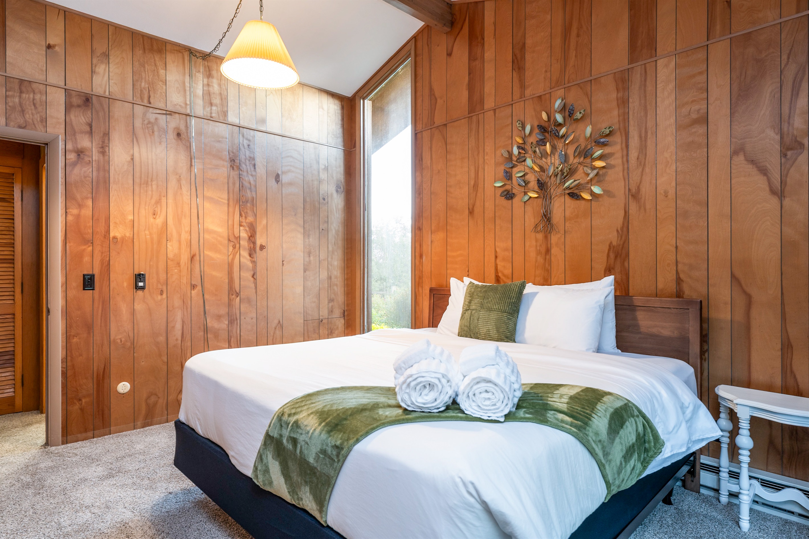 Inviting bedroom with cozy wood accents and fresh linens, designed for restful nights.