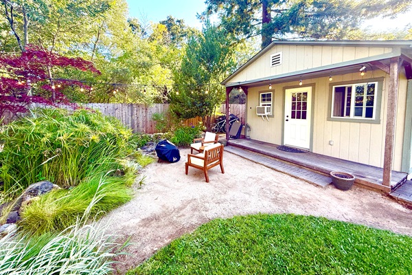 Front view of the home nestled among trees & greenery
