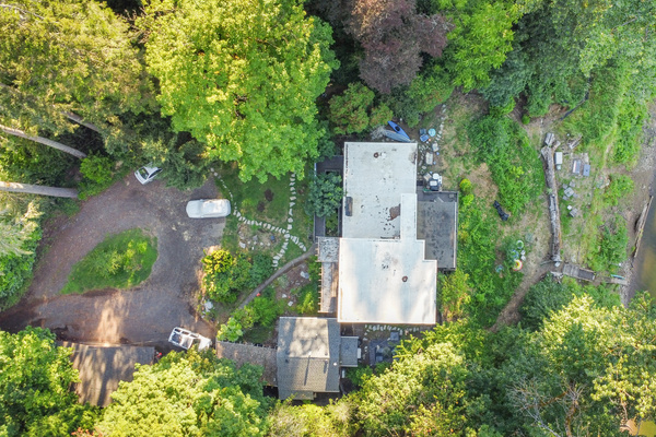 Straight down over the riverbank — the private cottage is your space; the main house is your hosts'.
