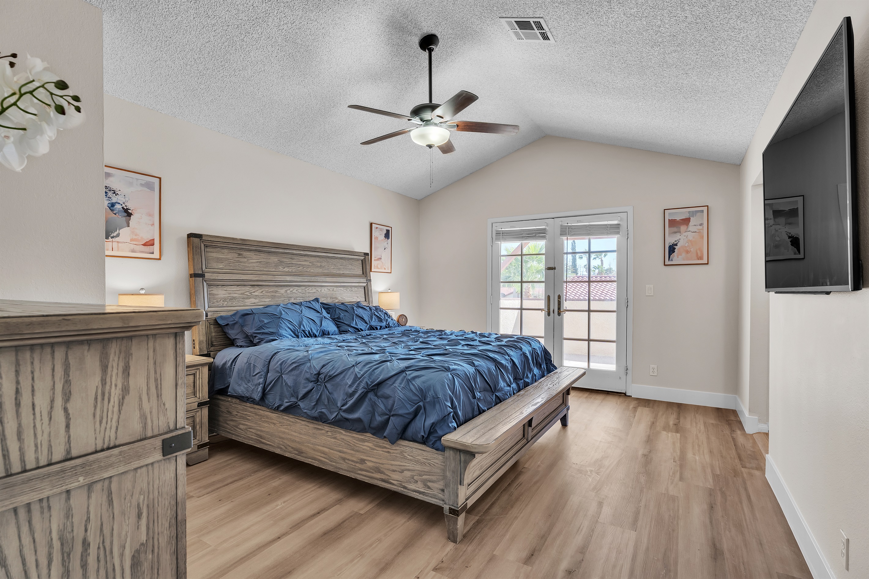 Bedroom 4 with king bed, 60 inch smart tv, walk in closet with table/chair, ensuite bathroom, and dresser