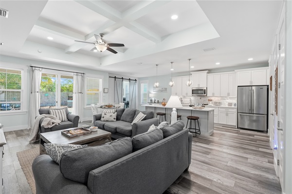 Make yourself comfortable at in the main living room, with open plan living, a beautiful vaulted ceiling, a huge island, large streaming TV, coffee table and tons of games