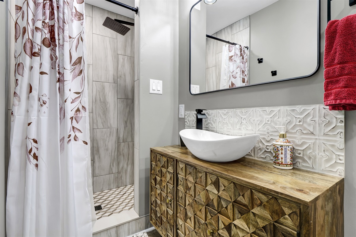 The master bath waterfall shower is just one of many luxurious upgrades to the cottage.