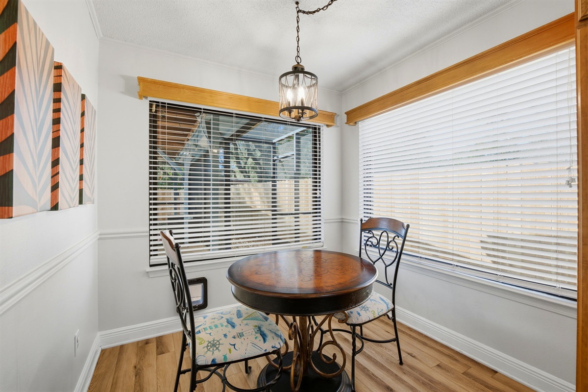 This cozy dining nook is the perfect spot to enjoy morning coffee or a quiet meal. Surrounded by large windows that bring in natural light, the charming table for two creates a warm and inviting atmosphere.