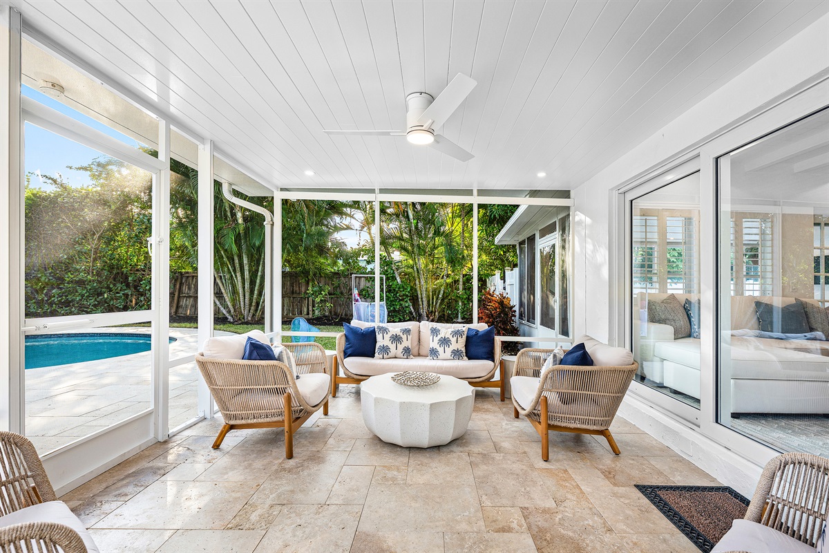 Al Fresco Living! The covered patio offers comfortable outdoor seating and dining, letting you enjoy the Florida weather year-round.